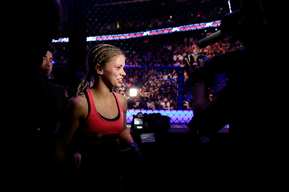 Paige VanZant celebrates defeating Felice Herrig in their women's strawweight bout during the UFC Fight Night event at Prudential Center on April 18, 2015 in Newark, New Jersey.