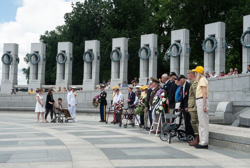 WWII veterans and guests lay wreaths at the Atlantic arch during a ceremony marking the 74th anniversary of the D-Day landings in Normandy at the World War II Memorial in Washington, DC, on June 6, 2018. 