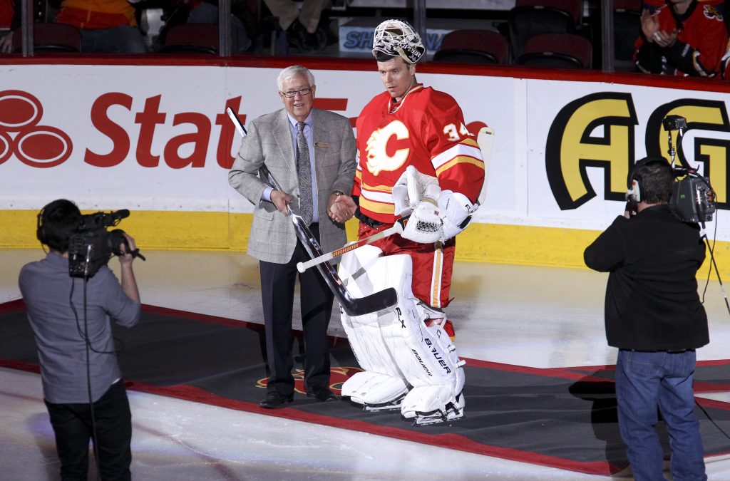 Miikka Kiprusoff #34 of the Calgary Flames receives a silver stick from Clay Riddell.