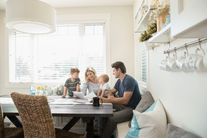 Keeping your kids safe online: family using tablet in kitchen nook