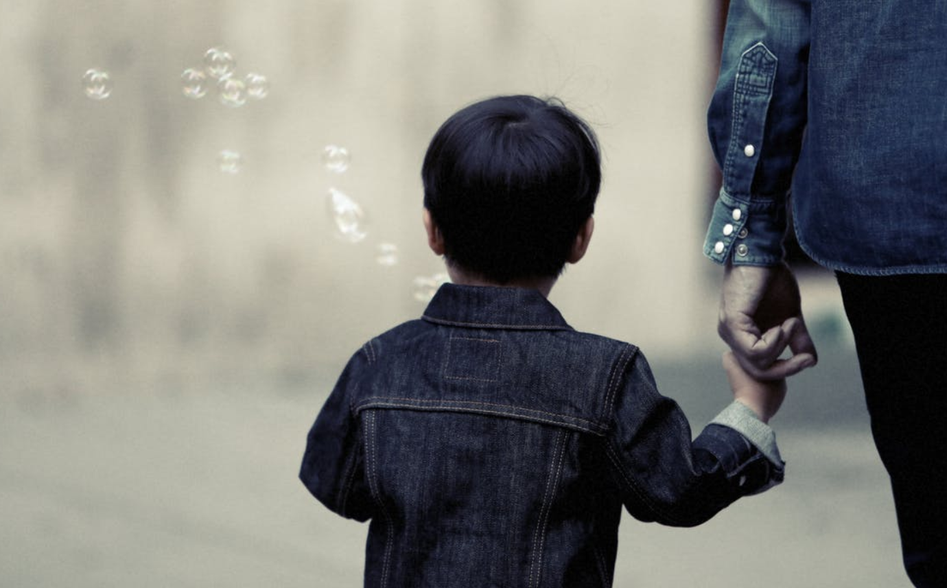 Helping kids cope with separation anxiety in the school setting: Child holding his father's hand